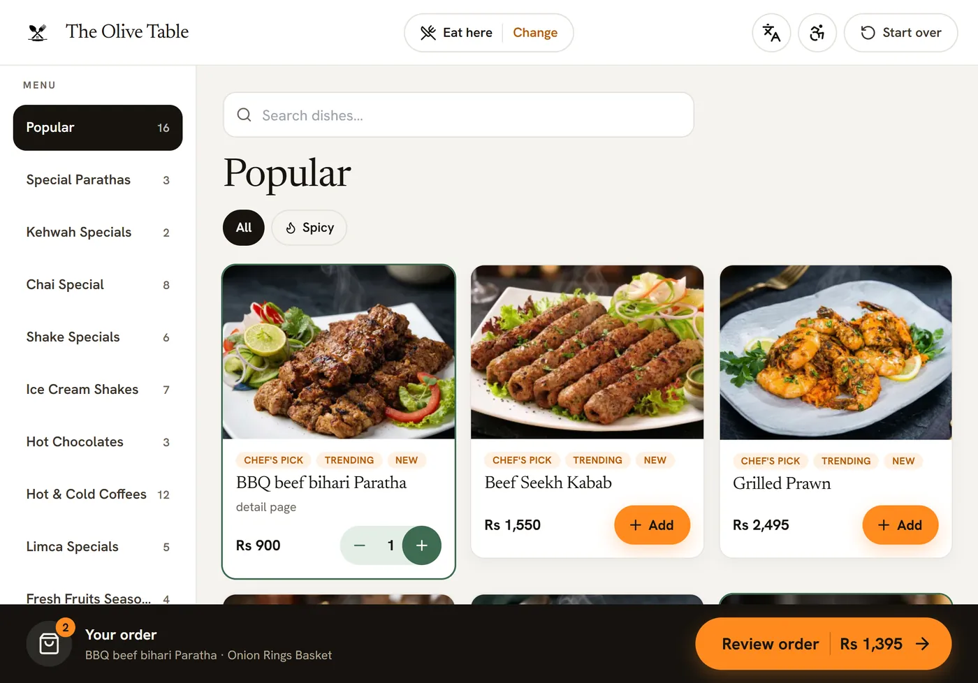 The real VizuDine guest kiosk menu: categories down the side, a Popular row of dish photos with Chef's pick, Trending and New badges, Add buttons and a Review order bar