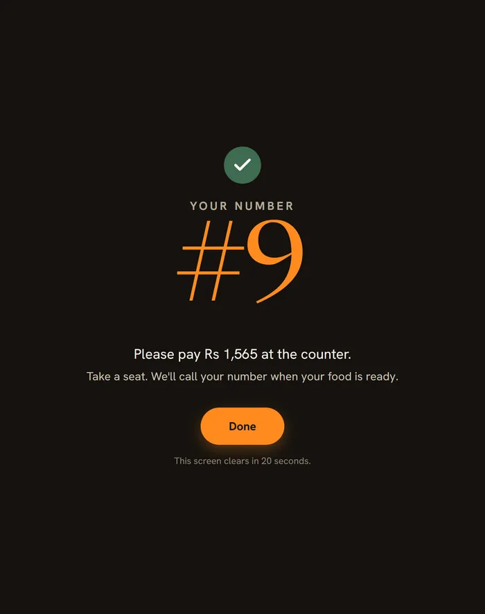 The kiosk confirmation: the guest's pickup number and Please pay at the counter